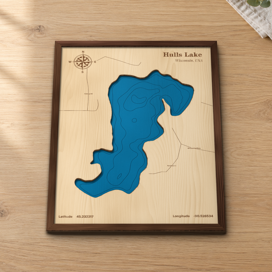 Hulls Lake wood map lying flat on a wooden tabletop, showing the depth contours engraved in