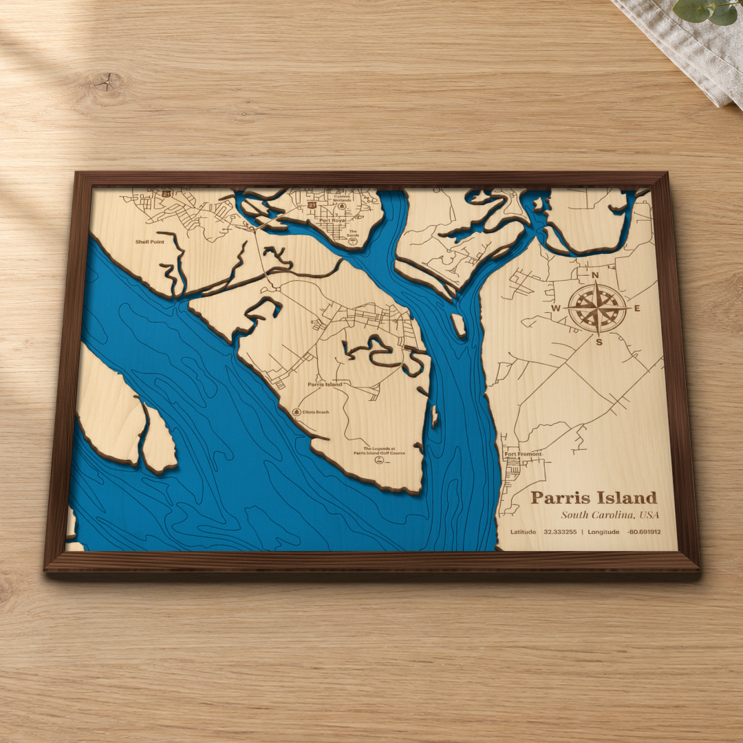 Parris Island wood map lying flat on a wooden tabletop, showing the island, Port Royal and the depth contours of the surrounding rivers