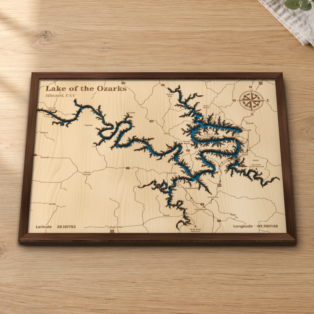 Lake of the Ozarks layered wood map in a stained walnut frame lying on a wooden tabletop