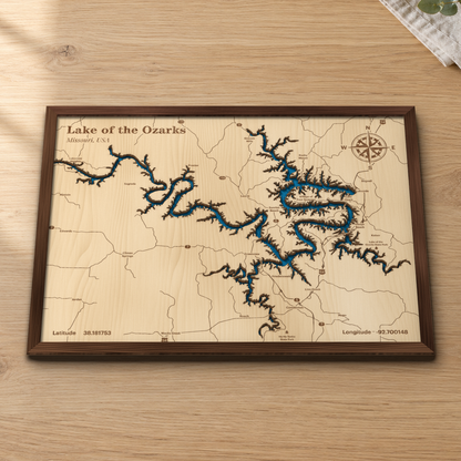 Lake of the Ozarks layered wood map in a stained walnut frame lying on a wooden tabletop
