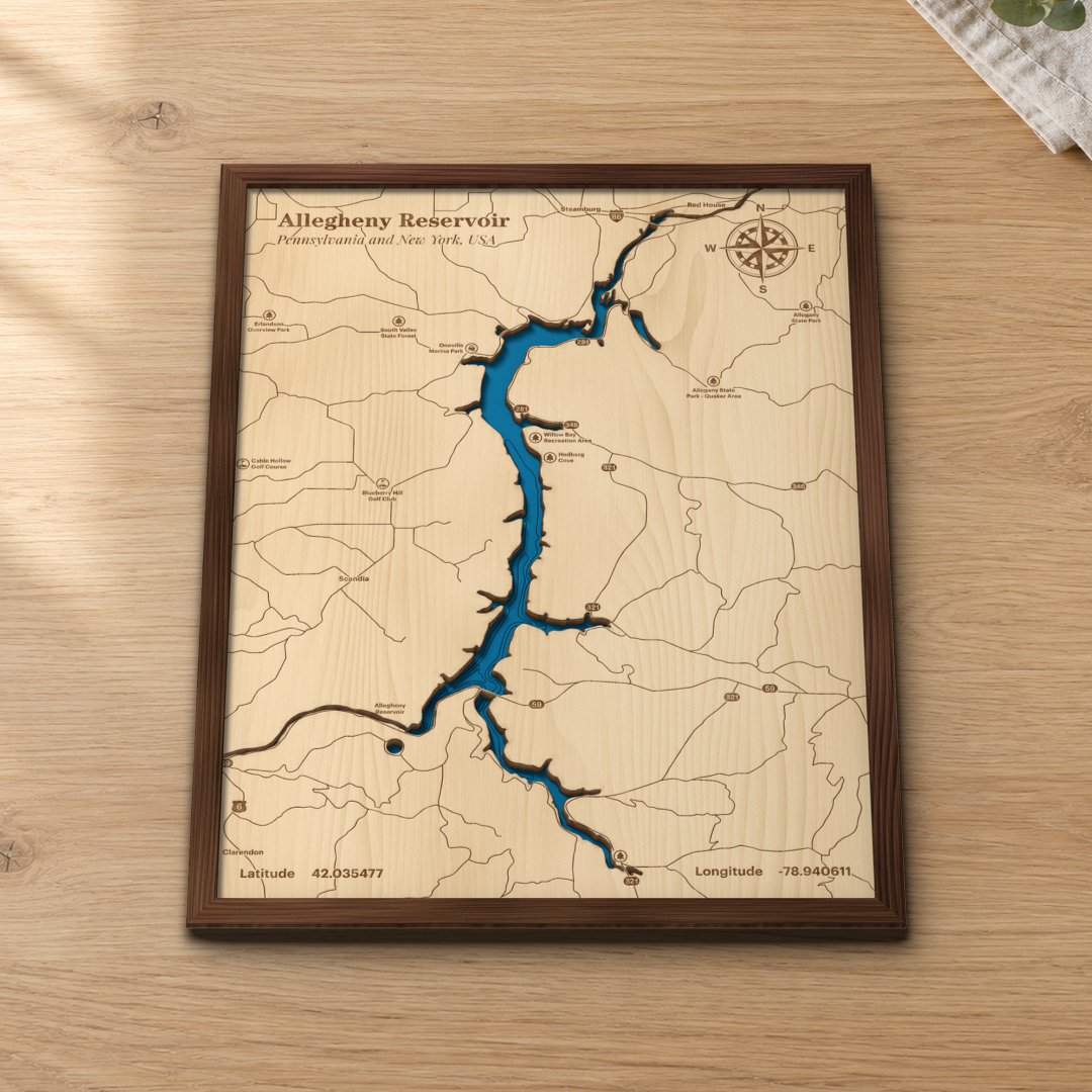 Allegheny Reservoir wood map lying flat on a wooden tabletop, showing the depth contours and the reservoir from Kinzua to Steamburg engraved in
