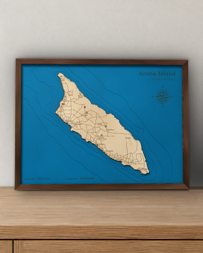 Aruba wood map in a walnut frame standing on a wooden sideboard against a wall for scale