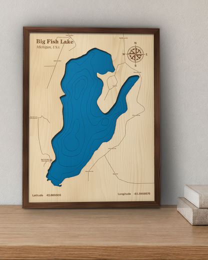 Big Fish Lake wood map in a walnut frame standing on a wooden sideboard against a wall for scale