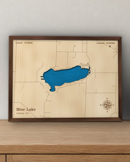 Blue Lake wood map in a walnut frame standing on a wooden sideboard against a wall for scale