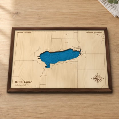 Blue Lake wood map lying flat on a wooden tabletop, showing the depth contours and the roads around the shore engraved in