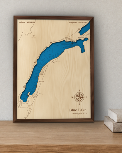 Blue Lake wood map in a walnut frame standing on a wooden sideboard against a wall for scale