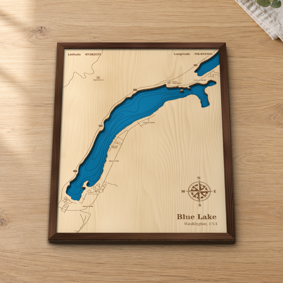 Blue Lake wood map lying flat on a wooden tabletop, showing the lake's depth contours with the coulee roads, Coulee Lodge Resort and State Route 17 engraved in
