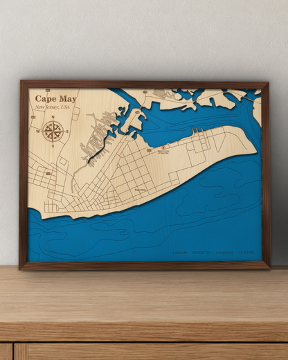 Cape May wood map in a walnut frame standing on a wooden sideboard against a wall for scale