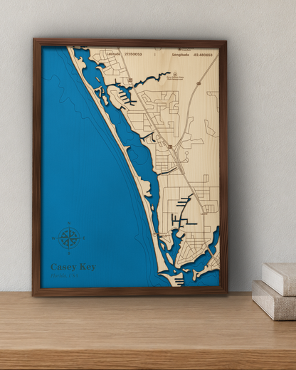 Casey Key wood map in a walnut frame standing on a wooden sideboard against a wall for scale
