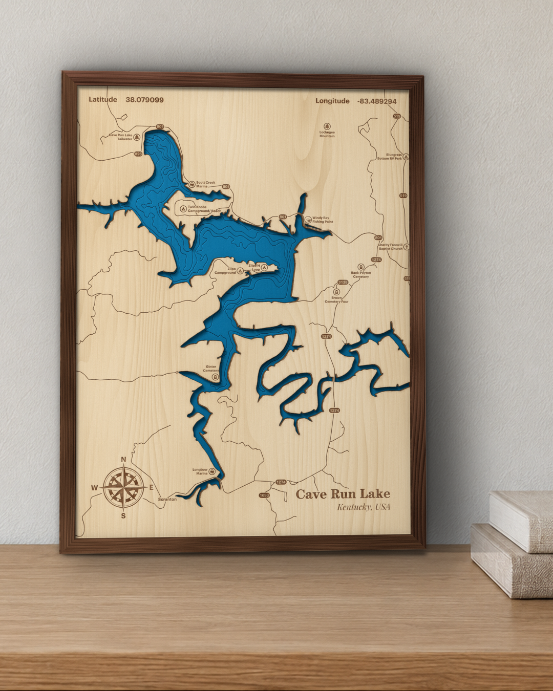 Cave Run Lake wood map in a walnut frame standing on a wooden sideboard against a wall for scale