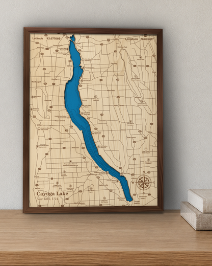 Cayuga Lake wood map in a walnut frame standing on a wooden sideboard against a wall for scale
