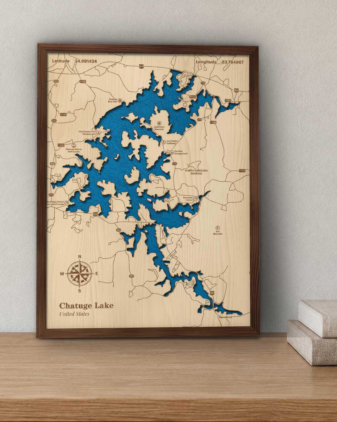 Chatuge Lake wood map in a walnut frame standing on a wooden sideboard against a wall for scale