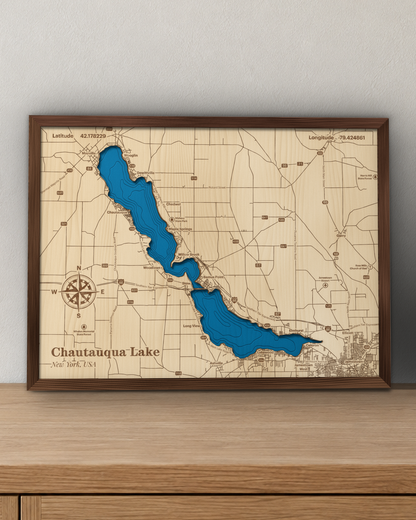 Chautauqua Lake wood map in a walnut frame standing on a wooden sideboard against a wall for scale