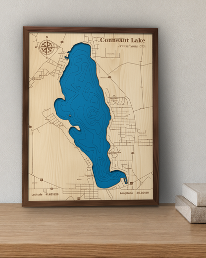 Conneaut Lake wood map in a walnut frame standing on a wooden sideboard against a wall for scale