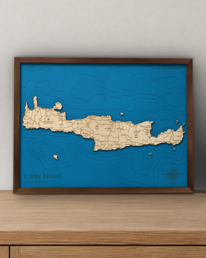 Crete wood map in a walnut frame standing on a wooden sideboard against a wall for scale