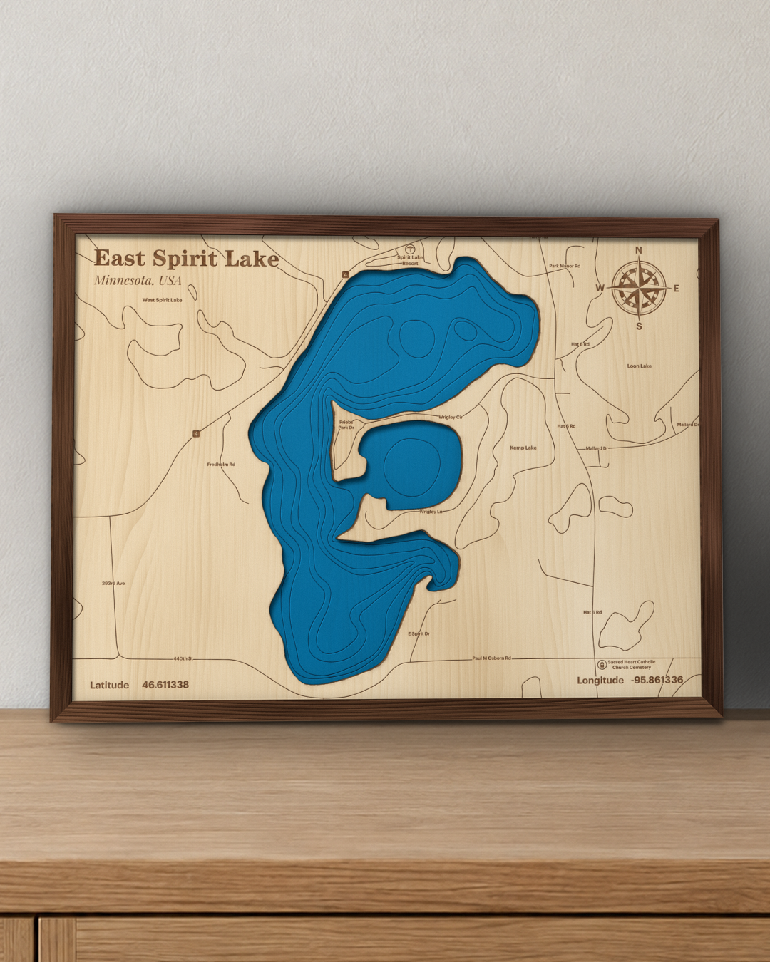East Spirit Lake wood map in a walnut frame standing on a wooden sideboard against a wall for scale