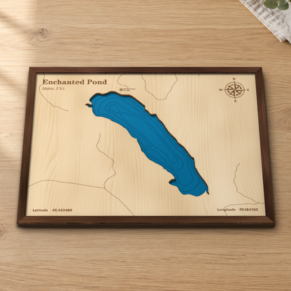 Enchanted Pond wood map lying flat on a wooden tabletop, showing the depth contours engraved in
