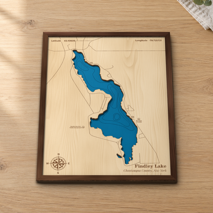 Findley Lake wood map lying flat on a wooden tabletop, showing the depth contours and Route 426 along the shore engraved in