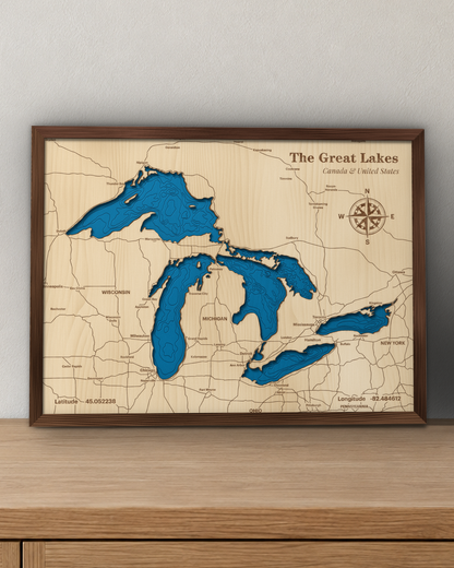 Great Lakes wood map in a walnut frame standing on a wooden sideboard against a wall for scale