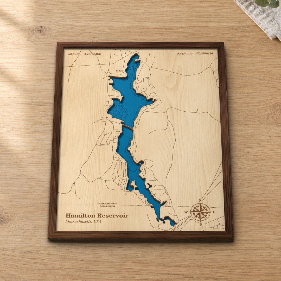 Hamilton Reservoir wood map lying flat on a wooden tabletop, showing the depth contours engraved in