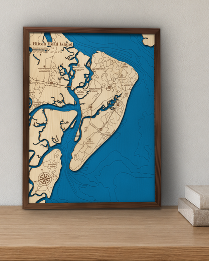 Hilton Head Island wood map in a walnut frame standing on a wooden sideboard against a wall for scale