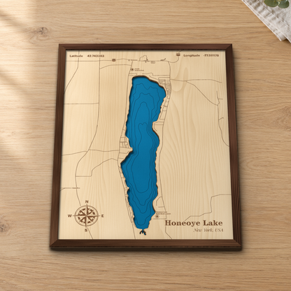 Honeoye Lake wood map lying flat on a wooden tabletop, showing the lake's depth contours with Honeoye, Sandy Bottom Park and the State Boat Launch engraved in