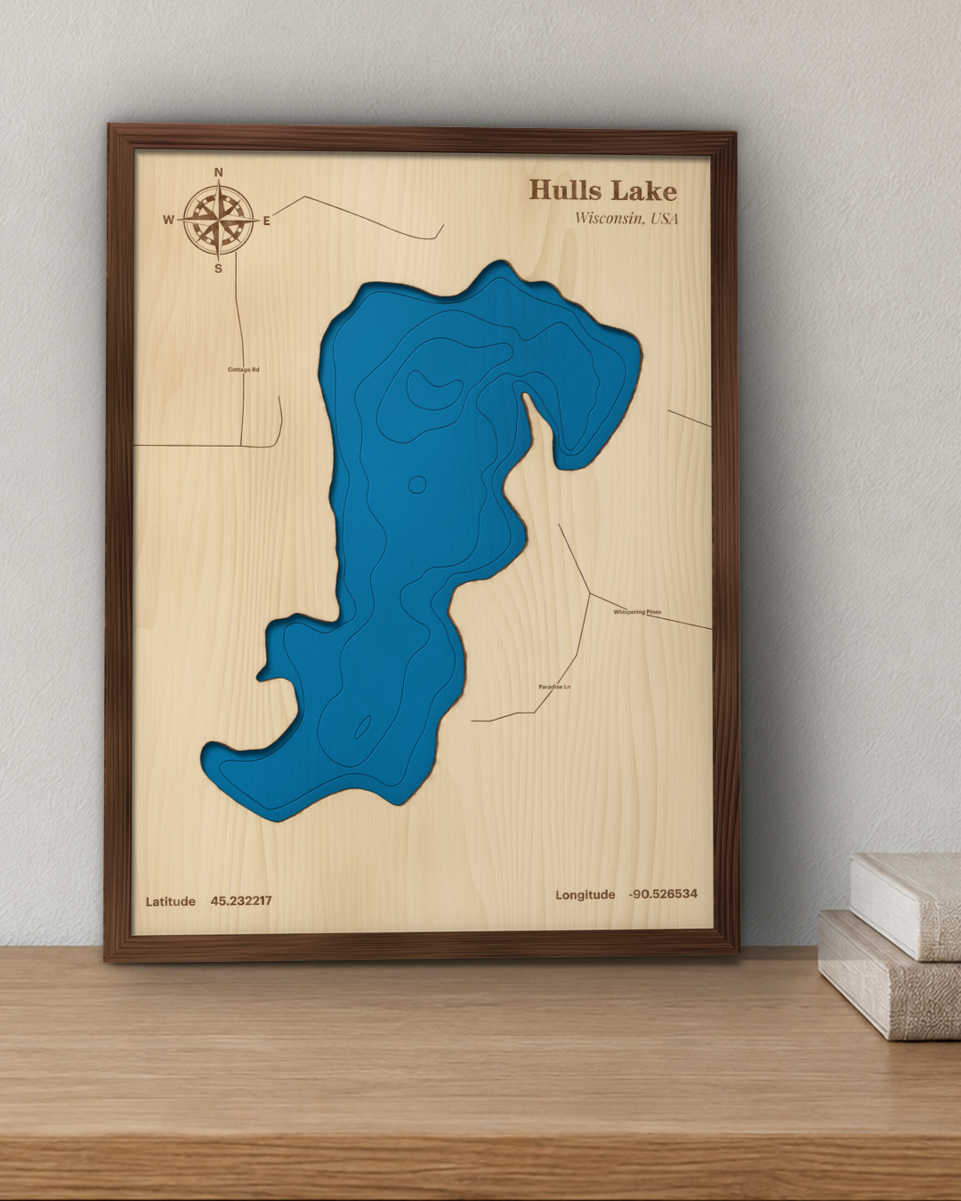Hulls Lake wood map in a walnut frame standing on a wooden sideboard against a wall for scale