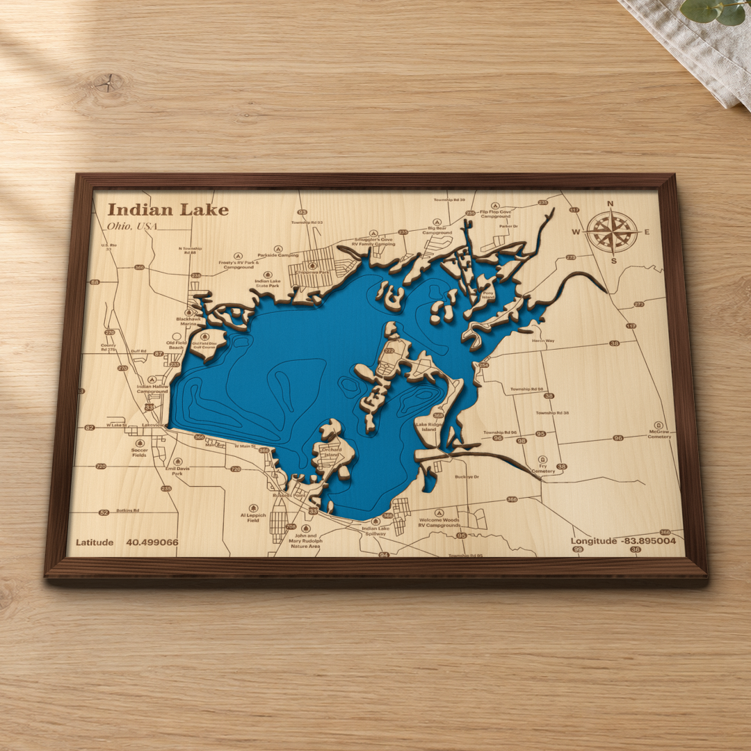 Indian Lake wood map lying flat on a wooden tabletop, showing the depth contours, the islands and Russells Point engraved in