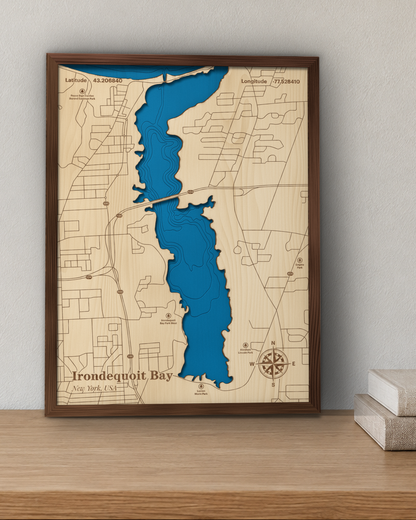 Irondequoit Bay wood map in a walnut frame standing on a wooden sideboard against a wall for scale