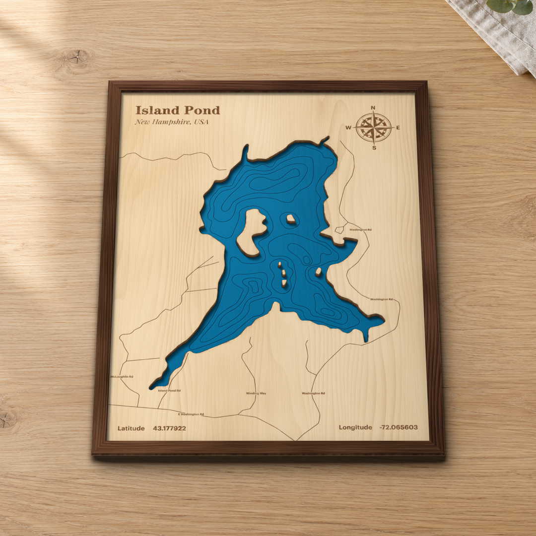 Island Pond wood map lying flat on a wooden tabletop, showing the depth contours and islands engraved in