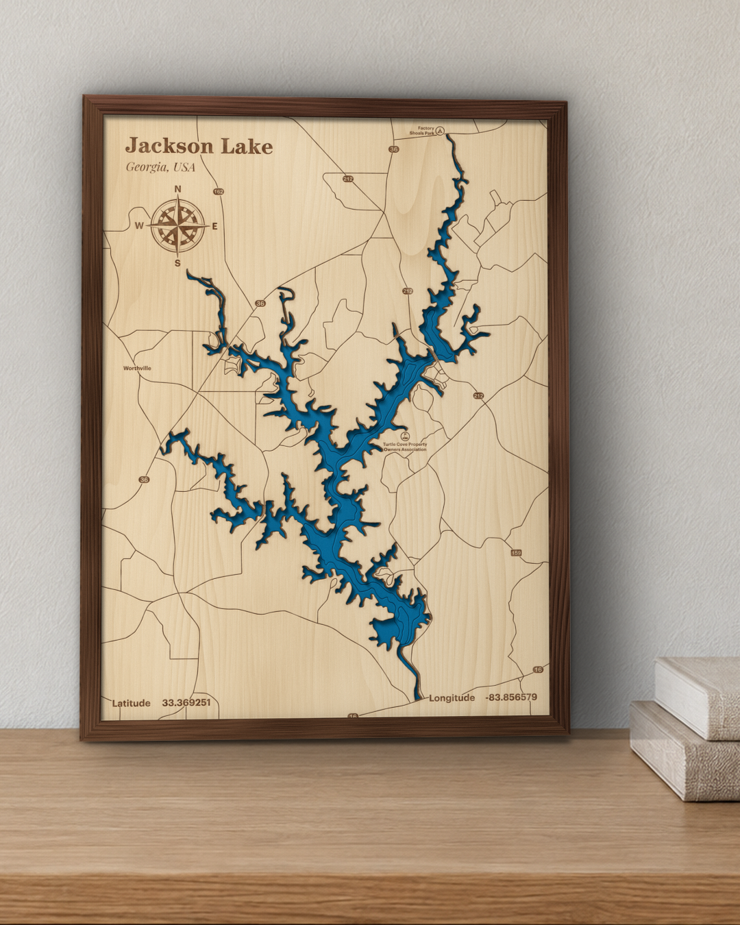 Jackson Lake wood map in a walnut frame standing on a wooden sideboard against a wall for scale