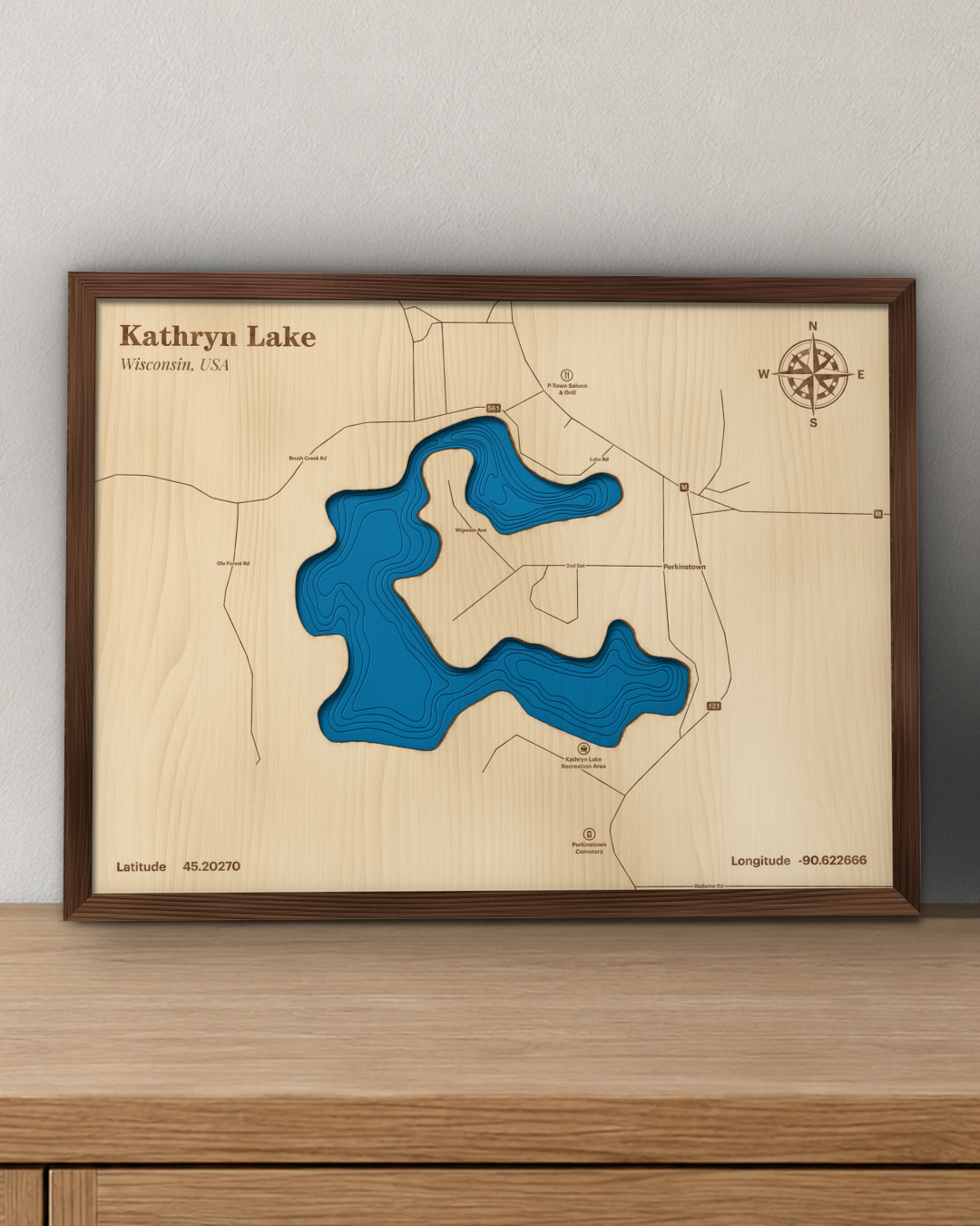 Kathryn Lake wood map in a walnut frame standing on a wooden sideboard against a wall for scale