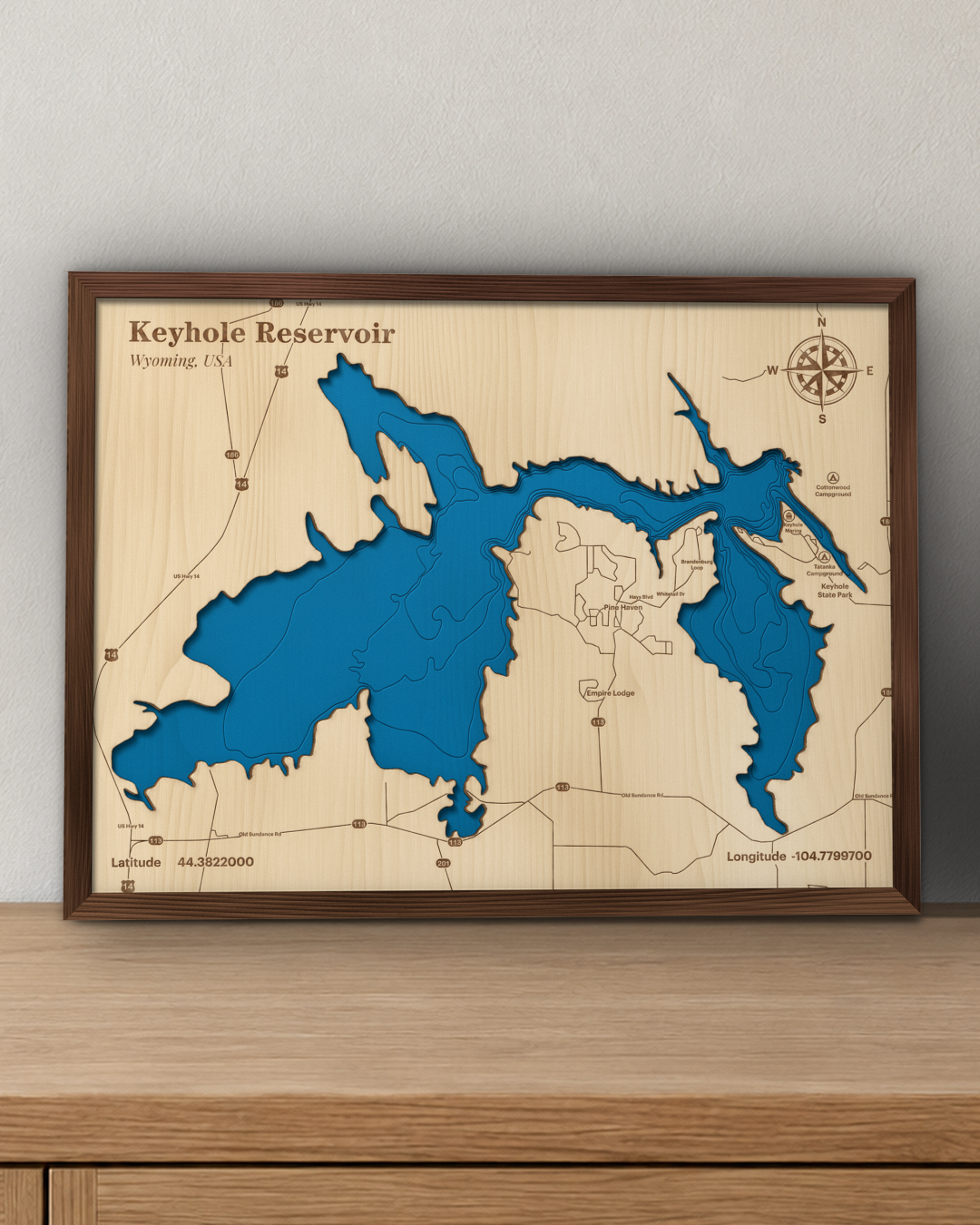 Keyhole Reservoir wood map in a walnut frame standing on a wooden sideboard against a wall for scale