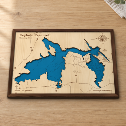 Keyhole Reservoir wood map lying flat on a wooden tabletop, showing the reservoir's depth contours with Keyhole State Park, Keyhole Marina and Pine Haven engraved in