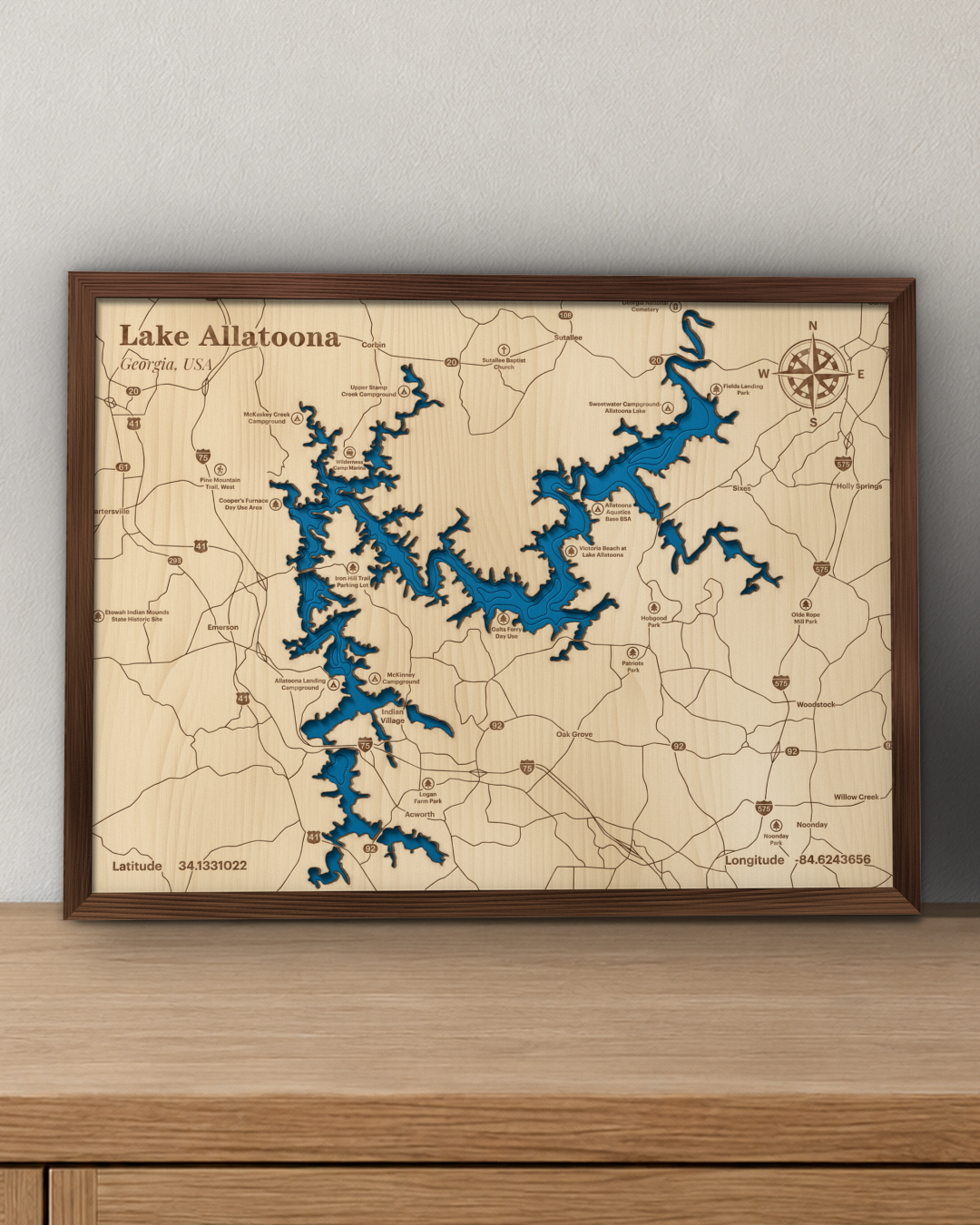 Lake Allatoona wood map in a walnut frame standing on a wooden sideboard against a wall for scale