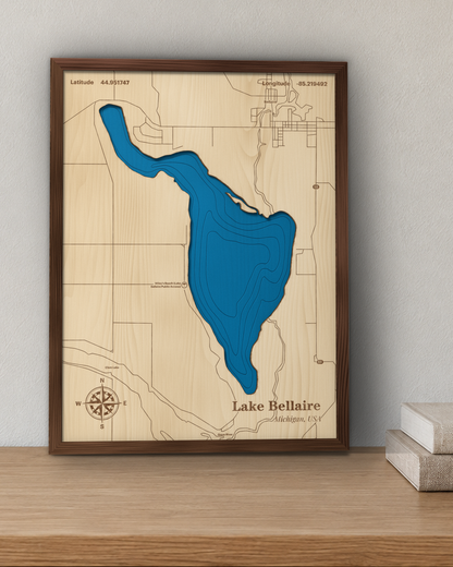 Lake Bellaire wood map in a walnut frame standing on a wooden sideboard against a wall for scale