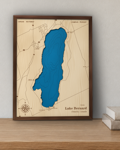 Lake Bernard wood map in a walnut frame standing on a wooden sideboard against a wall for scale