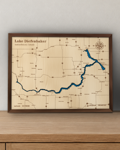 Lake Diefenbaker wood map in a walnut frame standing on a wooden sideboard against a wall for scale