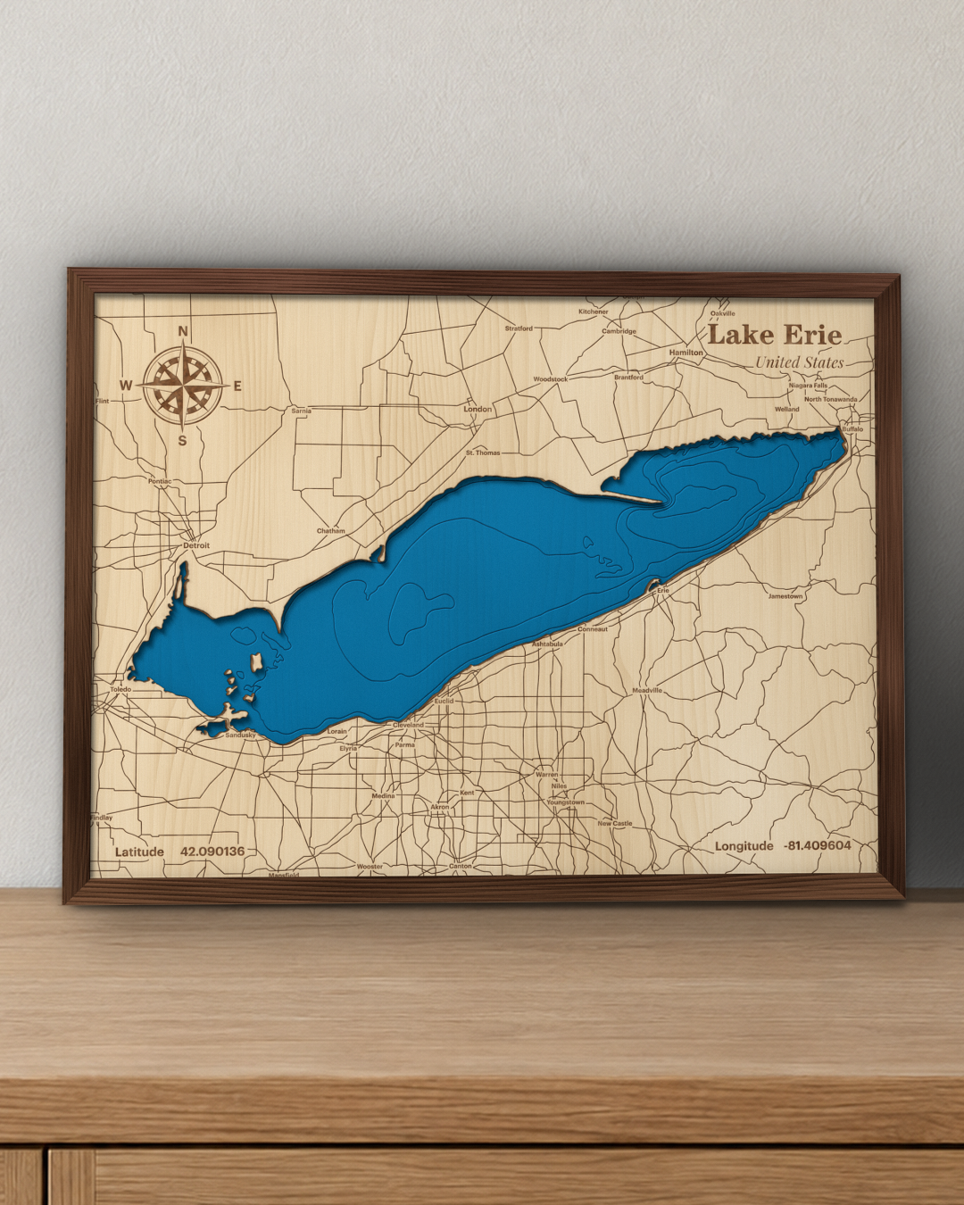 Lake Erie wood map in a walnut frame standing on a wooden sideboard against a wall for scale