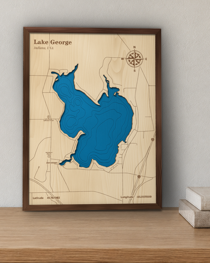 Lake George wood map in a walnut frame standing on a wooden sideboard against a wall for scale