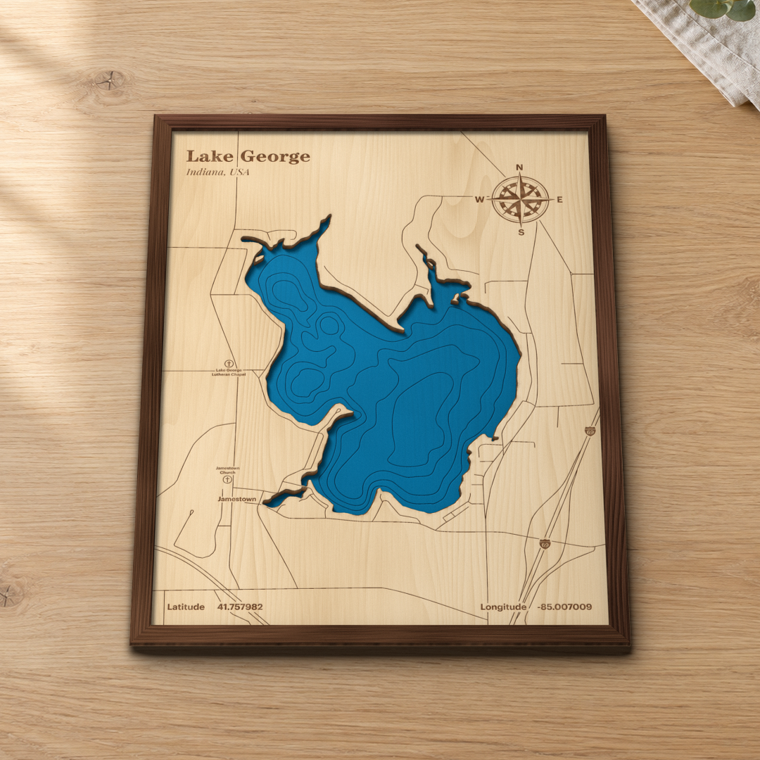 Lake George wood map lying flat on a wooden tabletop, showing the lake's depth contours, Jamestown and I-69