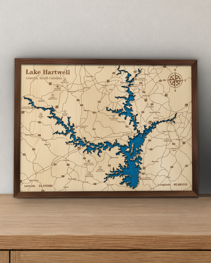Lake Hartwell wood map in a walnut frame standing on a wooden sideboard against a wall for scale