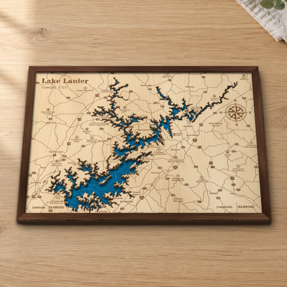Lake Lanier wood map lying flat on a wooden tabletop, showing the lake's winding arms and depth contours with Cumming, Flowery Branch and Lake Lanier Olympic Park engraved in