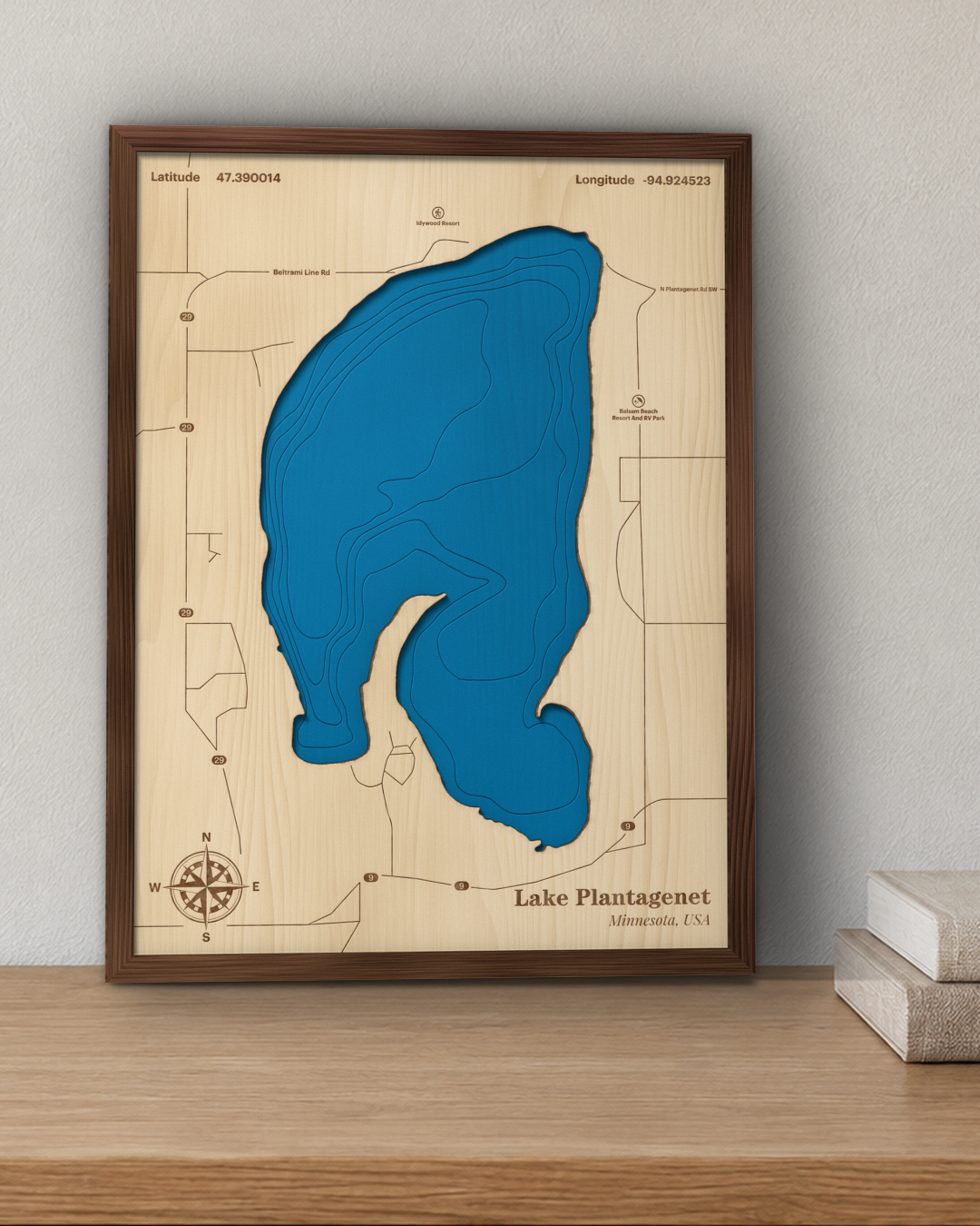 Lake Plantagenet wood map in a walnut frame standing on a wooden sideboard against a wall for scale