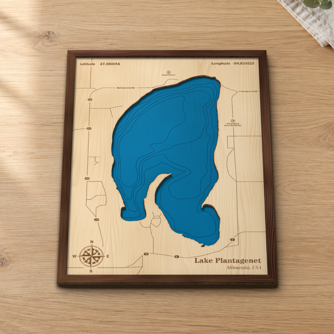 Lake Plantagenet wood map lying flat on a wooden tabletop, showing the depth contours and the roads around the shore engraved in