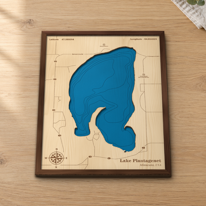 Lake Plantagenet wood map lying flat on a wooden tabletop, showing the depth contours and the roads around the shore engraved in