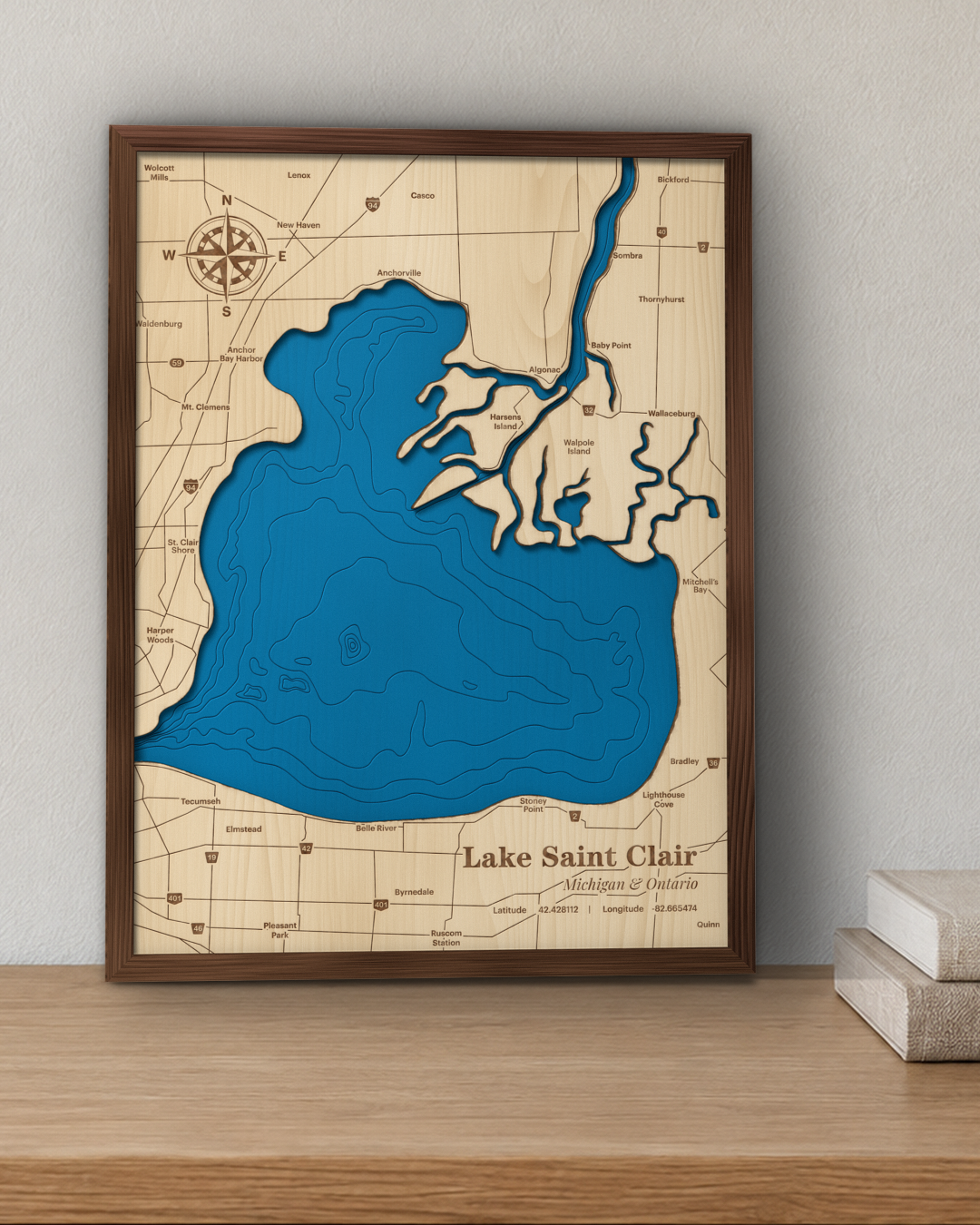 Lake Saint Clair wood map in a walnut frame standing on a wooden sideboard against a wall for scale