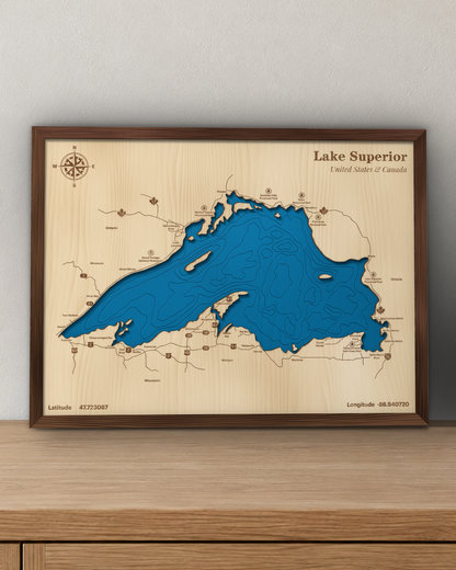 Lake Superior wood map in a walnut frame standing on a wooden sideboard against a wall for scale