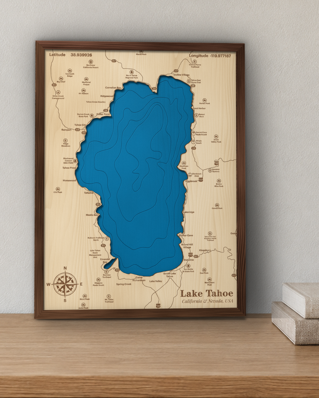 Lake Tahoe wood map in a walnut frame standing on a wooden sideboard against a wall for scale