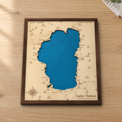 Lake Tahoe wood map lying flat on a wooden tabletop, showing the depth contours, Emerald Bay and the whole shoreline engraved in